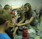 Sara helping kids at a "Make Your Own Trilobite Replica" workshop