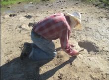 Joe Taylor cleans track with brush